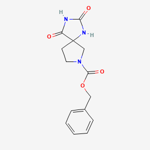 Chemical structure of Benzyl 2,4-dioxo-1,3,7-triazaspiro[4.4]nonane-7-carboxylate